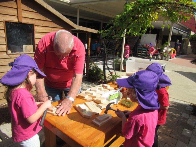 A local retired woodworker visits the Pre-School, working with the children in the outdoor program to teach them woodworking skills.