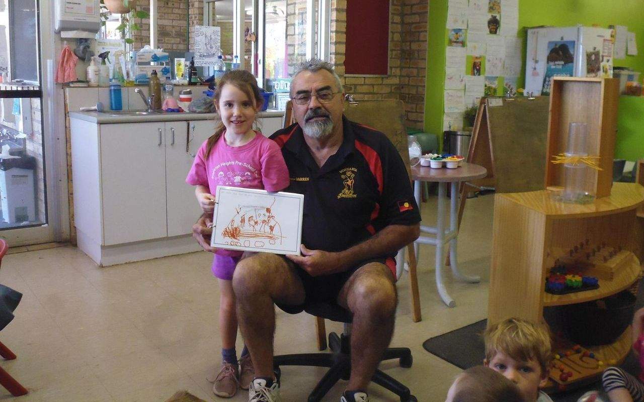 Children of Singleton Heights Pre-School present Warren Taggart with book about trip to the Baiame Cave